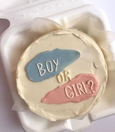 a cake in a box with the words boy or girl? on it's side