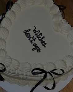 a white cake with black writing on it