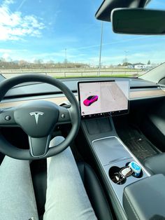 the interior of a car with an electronic device in the front seat and steering wheel