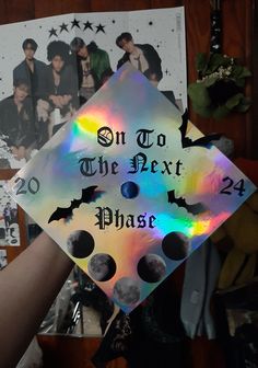 a graduation cap with the words on to the next phase and two pictures behind it