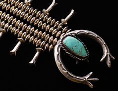 This is a nice Navajo sterling silver turquoise squash blossom necklace in good condition with 7mm saucer beads, a sand cast naja, and it's original patina. It tests positive for sterling and is 22 inches in length measured end to end and it's adjustable to 26 inches with the removable 4 inch sterling extender. The blossoms are 1 1/4 x 1/4 inches including the connectors, the naja is 1 7/8 x 1 3/4 inches, and it weighs 98.2 grams. The naja has a shepherd's hook bail that can be removed and worn with other beads or chains, and the squash blossom necklace can be worn with other najas and pendants that have a shepard's hook bail. Thanks for looking! Please conv me with any questions:). Turquoise Squash Blossom, Squash Blossom Necklace, Saint Paul Mn, Squash Blossom, Dec 7, Saint Paul, End To End, Silver Turquoise, Turquoise Sterling Silver