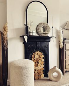 a living room with a fireplace and mirror