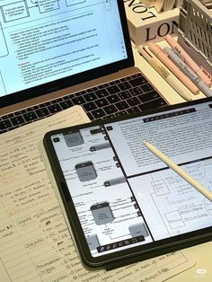 an open laptop computer sitting on top of a desk next to a calculator