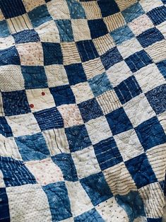 a blue and white checkered quilt is on display