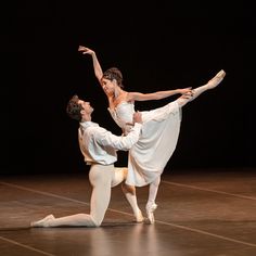 two ballerinas are performing on the stage