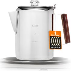 a white kettle with a wooden handle and label on the side that says boccman induction