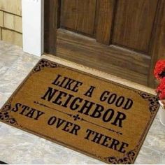 a door mat that says like a good neighbor stay over there on the front porch