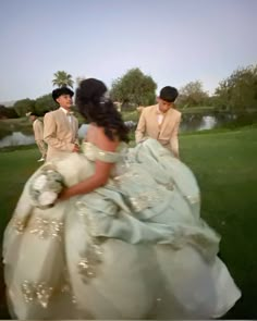 the bride and groom are walking through the grass