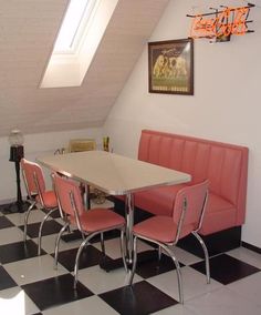 a table and chairs in a room with a checkered floor