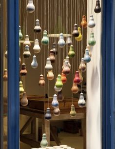 a window with many different colored lights hanging from it