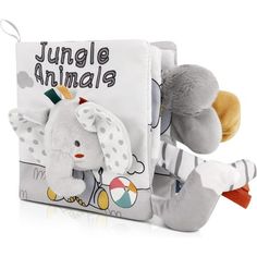 a stuffed animal is sitting in front of a book with an elephant on it's cover