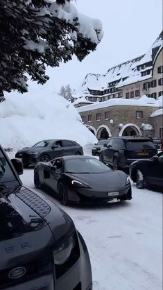 a bunch of cars that are parked in the snow