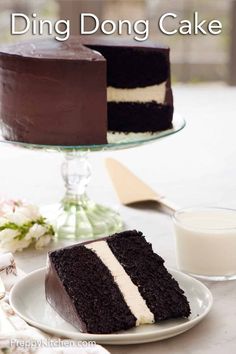 there is a chocolate cake with white stripes on it and a glass of milk next to it