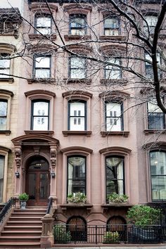 an apartment building with many windows and stairs