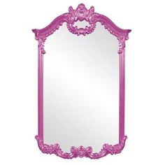 a pink mirror sitting on top of a white wall