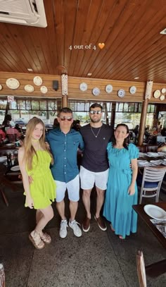 a group of people standing next to each other in front of a table with plates on it