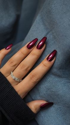 If you want to mix things up, why not try burgundy chrome nails with a matte finish? The combination of a chrome base and a matte top coat creates an interesting contrast between shine and texture. Matte nails have been a popular trend in recent years, offering a more subtle and sophisticated alternative to the typical glossy finish.  To achieve this look, apply a matte top coat over your burgundy chrome nails. This not only reduces the shine but also gives the nails a soft, velvety appearance. Burgundy Fall Nails 2024, Maroon Nails Almond Shape, Nails November 2023 Trends, Fall Nails 2024 November, Dark Autumn Nail Designs, Autom Nails 2024, Square Nail Designs Fall 2024, Acrylic Nails Fall 2024, 2024 Nails Fall