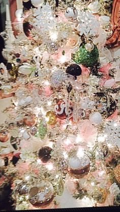 a christmas tree that is covered in ornaments and other things to decorate with it's lights on