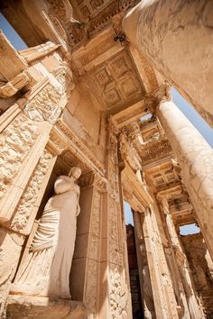 an ancient building with columns and statues