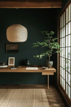 a room with green walls and wooden flooring has a plant on the table next to it