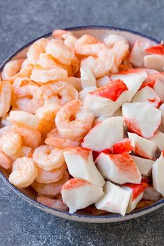 a bowl filled with shrimp and diced potatoes