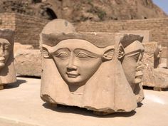 some ancient sculptures are on display in front of an old brick wall and rock structure