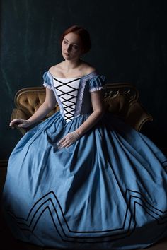 Blue cotton gown with contrasting velvet black trims is made after Hungarian fashion popular in 1860s Europe. It's the style Empress Sissi could wear during her Hungarian holidays. Such examples of military costume motifs were also popular during America Civil War in 1860s.The dress consists of the bodice and skirt. The skirt is one-layered, decorated with velvet trims. The bodice is boned and decorated with white laces and velvet trims as well.Please mind, the dress is sold without the hoopskir Queen Victoria Wedding Dress, Gone With The Wind Dresses, Victoria Wedding Dress, 1869 Fashion, Military Costume, Empress Sissi, Dress Sites, Military Costumes, 1800s Fashion