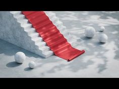 a red carpeted stair leading up to some white balls on the ground and in front of it