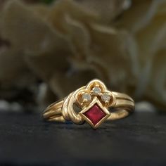 Vintage ruby and diamond ring from the 1980s designed in an Art Deco revival.  Stones: Princess cut ruby and round cut diamonds Metal: 14k yellow gold Ring Size: 6.5 but can be resized by a jeweler Time Period: 1980s  Free shipping in the USA. Art Deco Jewelry Rings, Vintage Ruby Ring, Ruby Ring Vintage, Rubin Ring, Art Deco Revival, Vintage Jewelry Rings, Ruby Ring Gold, Ruby And Diamond Ring, Vintage Jewellery Rings