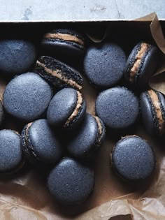 chocolate macaroons and oreos are sitting on wax paper