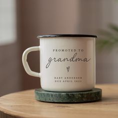 a white coffee mug sitting on top of a wooden table