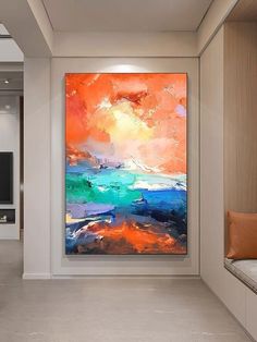 an abstract painting hangs on the wall next to a window in a modern living room