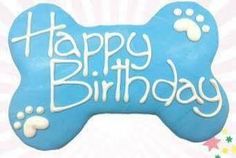 a dog bone shaped cookie with the words happy birthday written in frosting on it