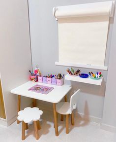 a child's desk and chair in the corner of a room with white walls