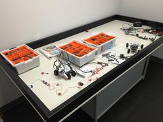 the table is covered with orange boxes and wires