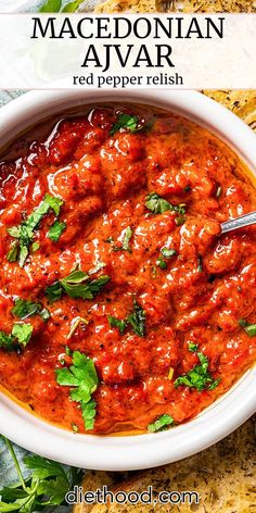 a white bowl filled with red pepper relish and garnished with cilantro