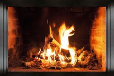 a fire burning in a fireplace with logs