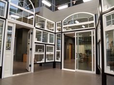 the inside of a building with multiple glass doors and windows on each side of it