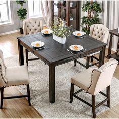 a dining room table with chairs around it