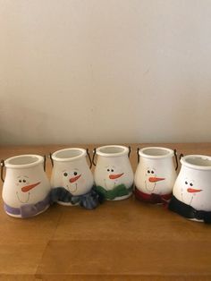 five snowmen are lined up on a table