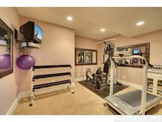 a home gym with exercise equipment and mirrors