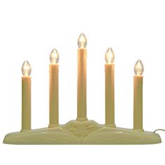 five candles are lit in front of a white background