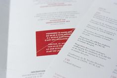 a close up of a red and white brochure with words on it's side