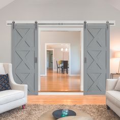 an open living room with sliding doors leading to the dining room