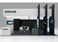 an exhibition booth with tables and chairs on display in front of the room, which has kohler's logo on it