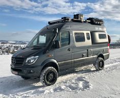 an rv parked on the side of a snow covered road