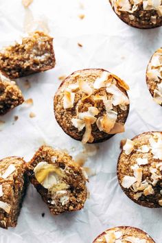 several muffins with coconut on top and one cut in half