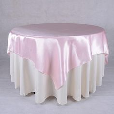 a round table with a pink satin overlay