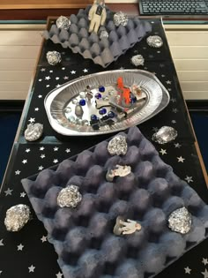 a table topped with trays filled with different types of items