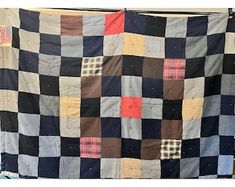 an old patchwork quilt hanging on a clothes line